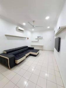 a living room with a black couch in a white room at Bukit Indah Nearby Aeon Issix 4 rooms up to 8 pax in Johor Bahru