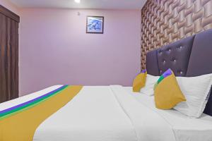 a bedroom with a bed with a rainbow bedspread at Itsy By Treebo - Royal Galaxy in Jahāngīrābād