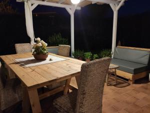 a wooden table with a potted plant on a patio at Appartamento relax con giardino in Caria