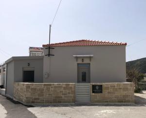 a small white building with a sign on it at Aphrodite’s Cozy House in Kolymvari