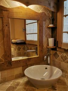 a bathroom with a sink and a mirror at Petit chalet individuel de caractère in Megève