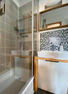 a bathroom with a shower and a sink and a tub at Auszeit Usedom in Heringsdorf