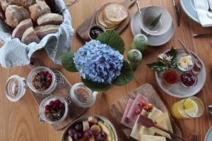 a wooden table with a bunch of different types of food at Furnas Lake Forest Living in Furnas