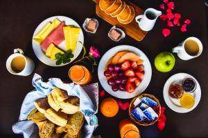 a table topped with plates of food and fruit at Furnas Lake Forest Living in Furnas