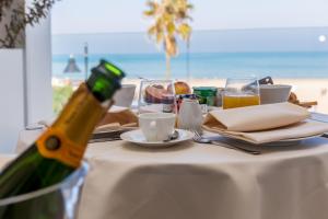 a bottle of champagne sitting on a table near the beach at EUROPA Hotel in Vasto