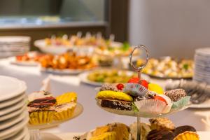 a table filled with different types of cakes and pastries at EUROPA Hotel in Vasto