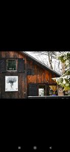 a wooden barn with a picture on the side of it at Chalet Baluma Maluba in Jahorina
