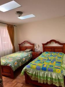 a bedroom with two beds and two night stands at Preciosa casita en Zona Residencial de La Paz in La Paz