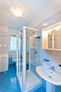 a bathroom with a shower and a sink at Residence Caravelle in Caorle