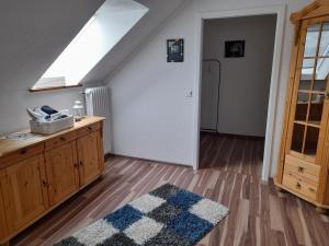 a attic room with a skylight and a kitchen with a rug at Ferienwohnung Dieblich in Dieblich