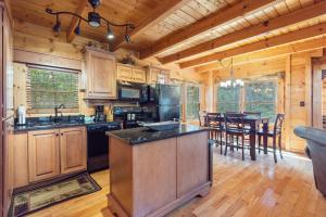 a kitchen with a large island in a log cabin at Bear Paw Trail in Sevierville