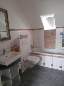 a bathroom with a white toilet and a sink at Ferienwohnung Dieblich in Dieblich