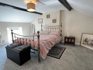 a bedroom with a bed with a wooden frame at Cottage on the Solway Coast in Port Carlisle