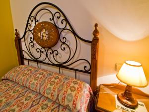 a bedroom with a bed with a lamp on a table at Apartamento EL RINCON DE MARIA in Santillana del Mar