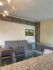 ein Wohnzimmer mit einem Sofa und einigen Stühlen in der Unterkunft Elite Home in Polykastro