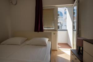 Postel nebo postele na pokoji v ubytování Apartmani Di-Ana