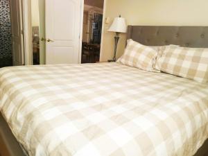 a bedroom with a bed with a checkered blanket at Desert Rose Villas - Private One Bedroom in Old Town Scottsdale in Scottsdale
