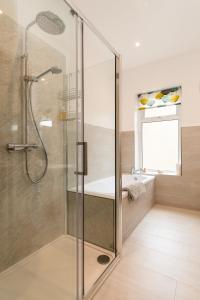 a glass shower in a bathroom with a sink at CRAVEN VUE - SKIPTON in Skipton +36 photos