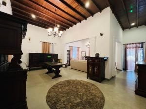 a living room with a table and a rug at Krishan Villa in Negombo