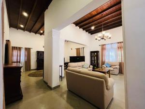 a living room with two couches and a table at Krishan Villa in Negombo