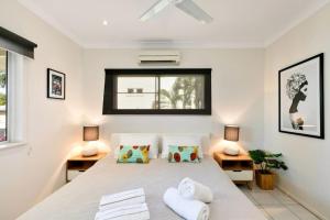 um quarto com uma cama grande e 2 candeeiros em Tiki Dreams - With A Large Breezy Balcony em Westcourt