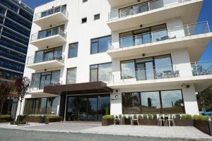 a large white building with a large window at Mizuumi Boutique Hotel in Mamaia