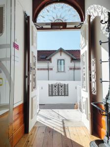 eine offene Tür in ein Zimmer mit einem Bett im Hintergrund in der Unterkunft Casa de São Bento St Benedict House in Coimbra