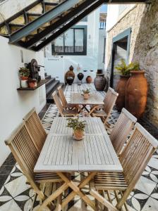 a wooden table and chairs on a patio at Casa de São Bento St Benedict House in Coimbra