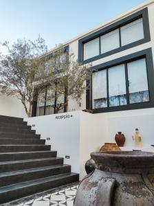 a building with stairs and a vase in front of it at Casa de São Bento St Benedict House in Coimbra