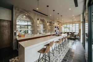 a large kitchen with a long bar with stools at Kings Mansion for 26 guests! in Tulum