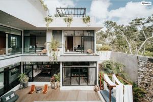 an exterior view of a house with large windows at Kings Mansion for 26 guests! in Tulum