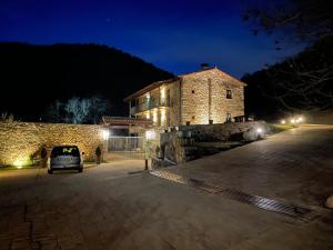 a car parked in front of a building at night at La Casassa de Ribes in Ribes de Freser