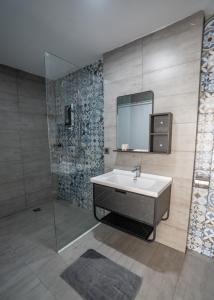 a bathroom with a sink and a mirror at Alice Villa Hotel in Takeo