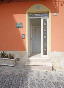 an entrance to a house with a white door at Gli Zii di Sicilia in Racalmuto