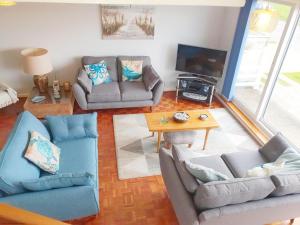 a living room with two couches and a television at Sea Breeze, Selsey in Selsey