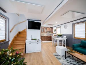 a living room with a staircase and a christmas tree at ALM SKI Jaworki in Jaworki