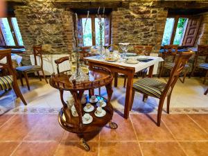 una sala da pranzo con tavolo e bicchieri di El Molino de la Ropería a Serrilla