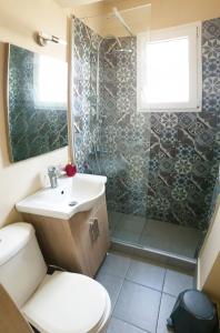 a bathroom with a toilet and a sink and a shower at Panoramic Penthouse in Chios