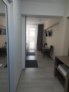 a hallway of a hotel room with a living room at Hotel Breaza in Breaza