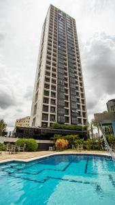 a large apartment building with a large swimming pool at Plaza Inn Small Town Flat in Sao Paulo