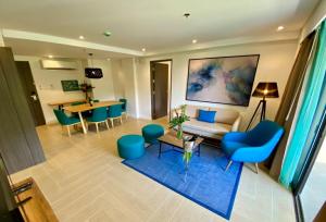 a living room with a couch and chairs and a table at Fairways and Bluewater Boracay in Boracay