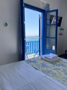 a bedroom with a bed with a view of the ocean at Cavos Studio by the sea (West) in Drios