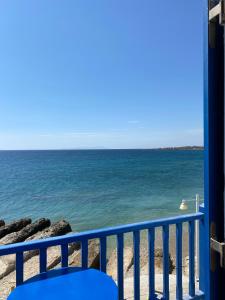 a view of the ocean from a balcony at Cavos Studio by the sea (West) in Drios