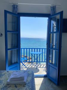 an open door to a balcony with a view of the ocean at Cavos Studio by the sea (West) in Drios +14 photos