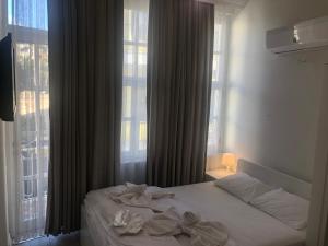 A bed or beds in a room at ATICI HOTEL