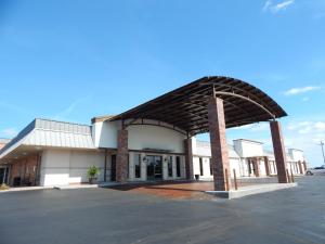 a building with awning in front of a parking lot at Quality Inn in Chickasha