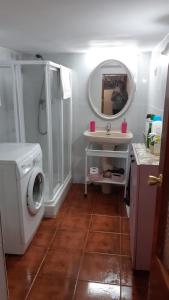 a bathroom with a sink and a washing machine at Casa Rural San Miguel in Saúca +41 photos