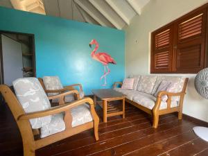 a living room filled with furniture and a couch at Westhill Bungalows & Diving in Sabana Westpunt