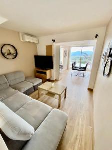 a living room with a couch and a table at Jolie maison Golfe de Saint-Tropez in Cogolin