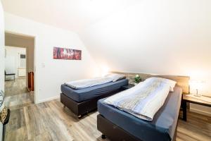 a room with two beds and a desk in it at Ferienwohnung Gerda in Lathen